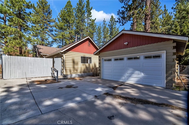 exterior space featuring a garage and an outbuilding