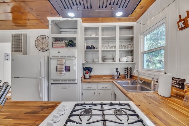 kitchen featuring white cabinetry, white appliances, butcher block counters, sink, and extractor fan