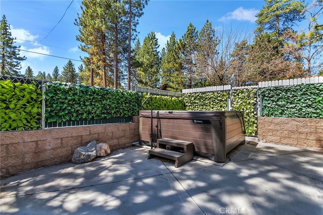 view of patio / terrace featuring a hot tub