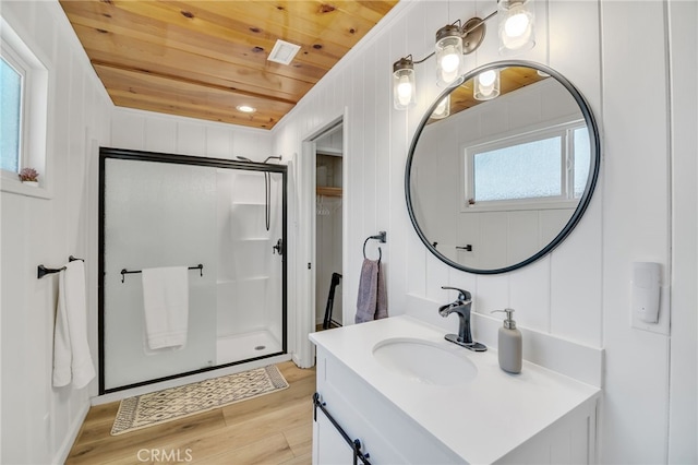 bathroom featuring vanity, hardwood / wood-style flooring, walk in shower, and wooden ceiling