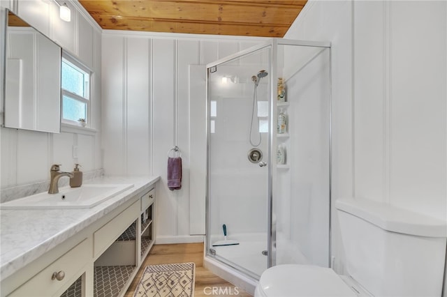 bathroom with wood ceiling, vanity, walk in shower, toilet, and hardwood / wood-style floors