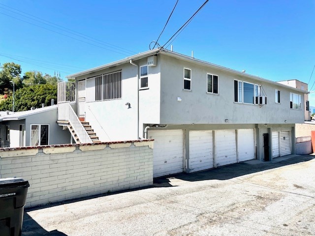 rear view of property featuring a garage