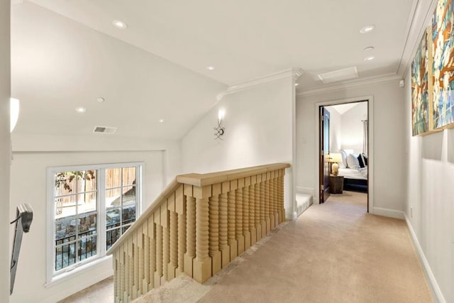 hall with light carpet, vaulted ceiling, and ornamental molding