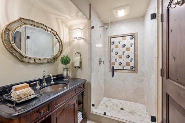 bathroom with vanity and a shower with door