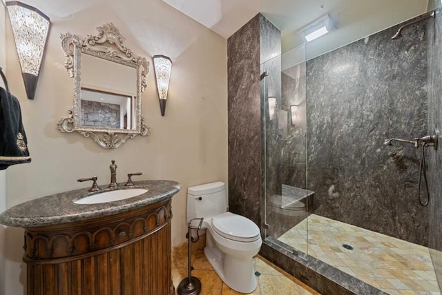 bathroom featuring tile patterned floors, vanity, toilet, and a shower with door