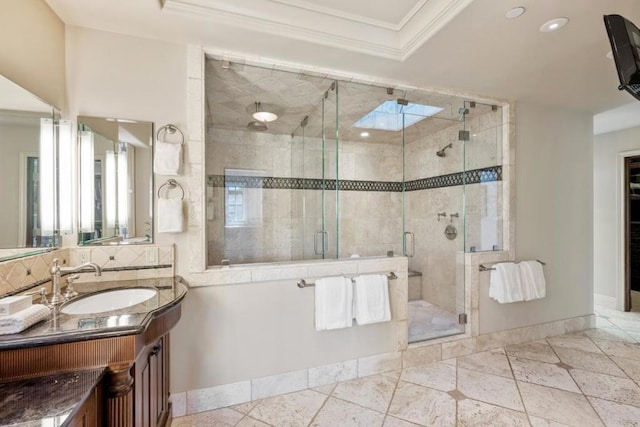 bathroom with vanity, tile patterned floors, a skylight, ornamental molding, and walk in shower