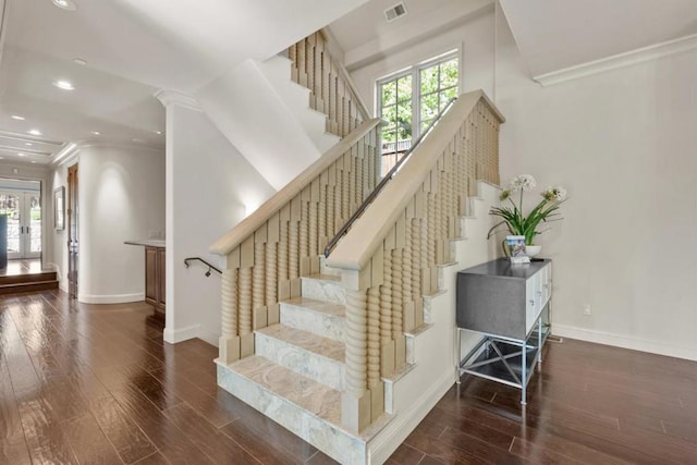 stairway featuring hardwood / wood-style flooring, a wealth of natural light, and ornamental molding