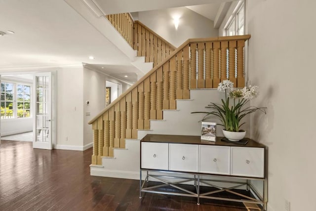 staircase featuring hardwood / wood-style floors and ornamental molding