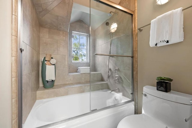 bathroom featuring toilet, lofted ceiling, and bath / shower combo with glass door