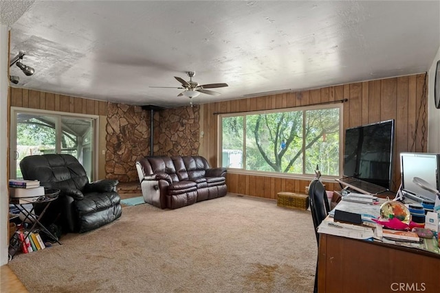 living room with ceiling fan, plenty of natural light, and carpet