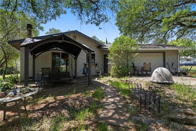 rear view of property featuring a garage