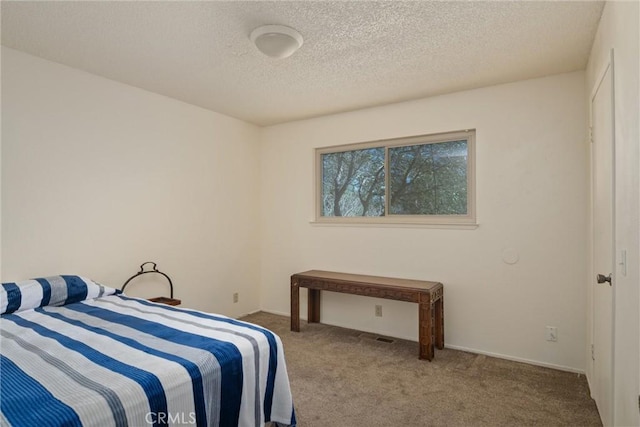 carpeted bedroom with a textured ceiling