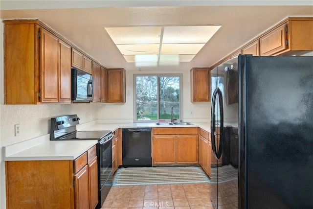 kitchen with black appliances, light tile patterned floors, and sink