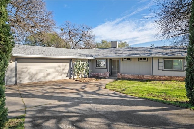 ranch-style home featuring a garage and a front yard