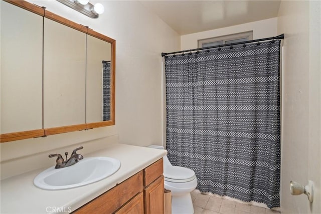 bathroom featuring vanity, curtained shower, and toilet