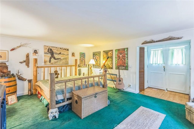 bedroom with hardwood / wood-style flooring, crown molding, and a closet