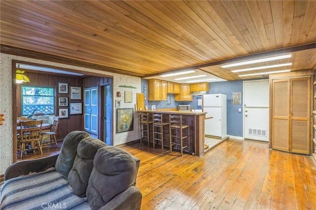 kitchen with white fridge, light hardwood / wood-style floors, kitchen peninsula, and wooden ceiling