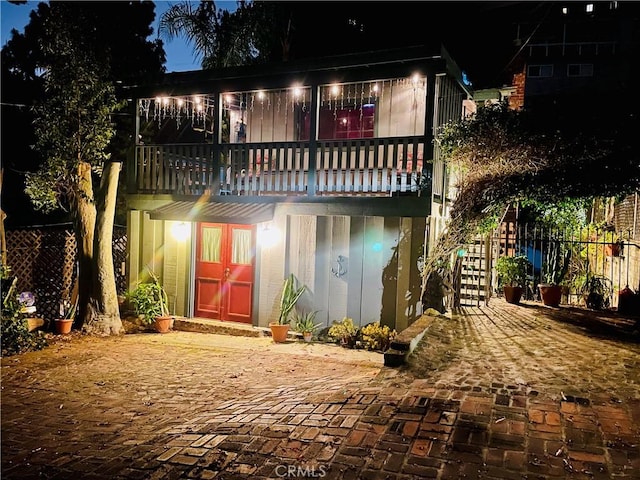 back house at twilight with a balcony