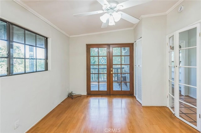 entryway with french doors, crown molding, vaulted ceiling, ceiling fan, and light wood-type flooring