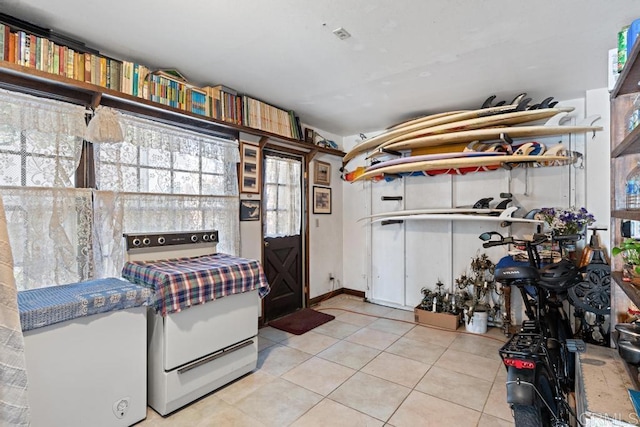 interior space with light tile patterned floors, open shelves, and white electric range oven