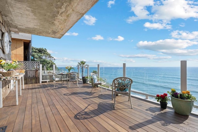 wooden terrace featuring a water view