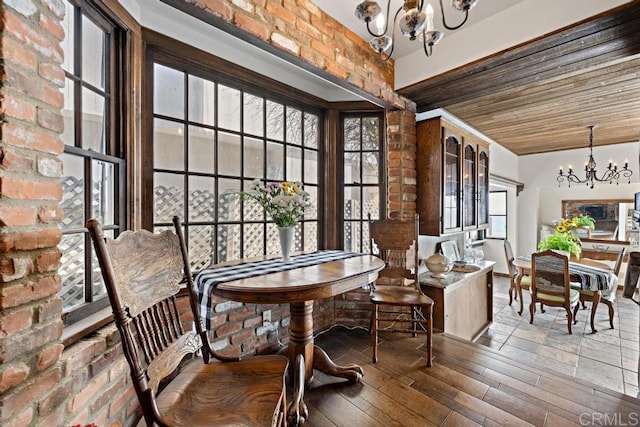 dining area with wooden ceiling, wood finished floors, and a chandelier