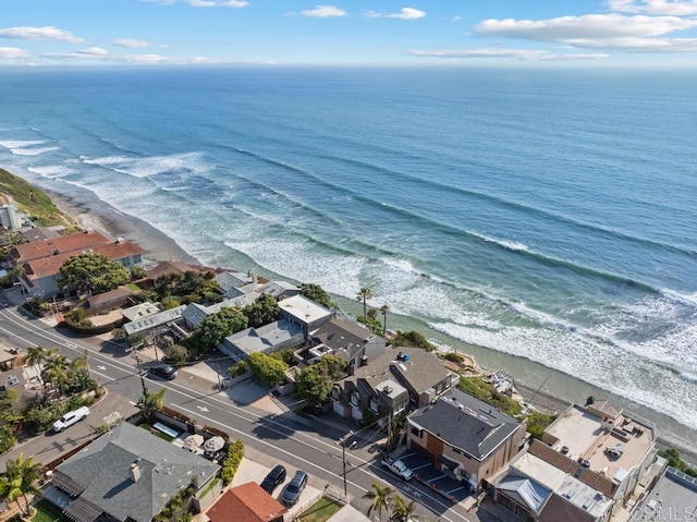 birds eye view of property featuring a view of the beach, a water view, and a residential view