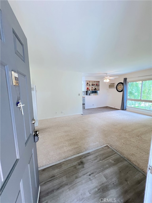 unfurnished living room featuring hardwood / wood-style floors and ceiling fan