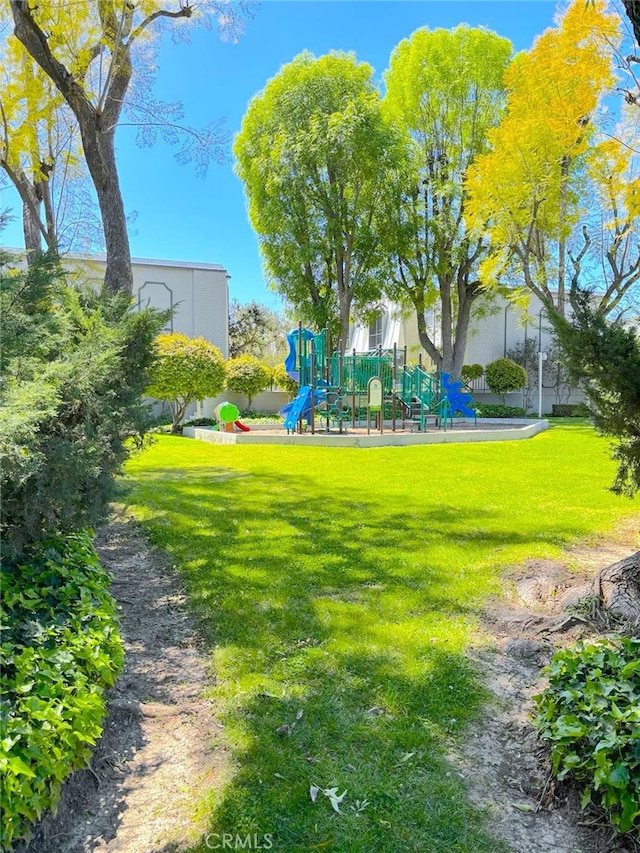 view of community featuring a lawn and a playground