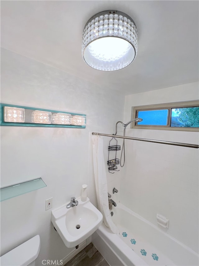 full bathroom with toilet, shower / tub combo, and sink