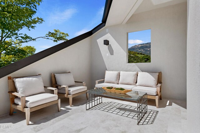 view of terrace featuring an outdoor living space and a mountain view