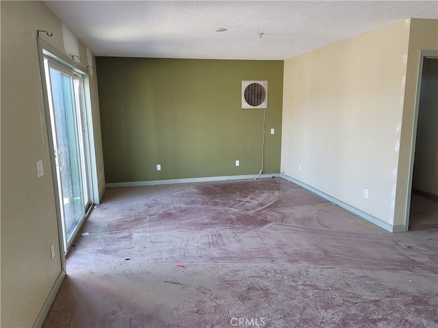 unfurnished room with plenty of natural light and a textured ceiling