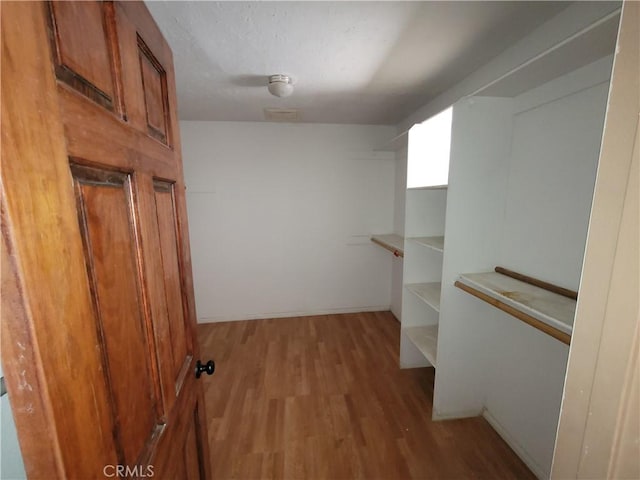 walk in closet featuring light hardwood / wood-style floors