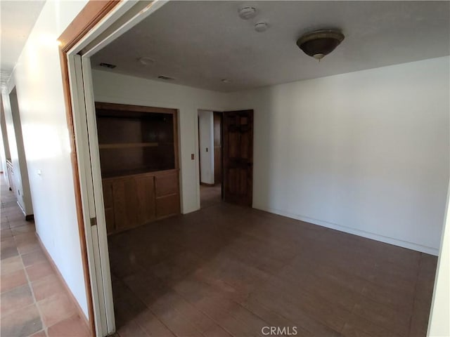 empty room with hardwood / wood-style flooring