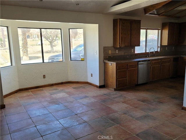 31801 Soapmine Rd, Barstow, CA 92311 - kitchen featuring dishwasher, wall chimney exhaust hood, decorative backsplash, and brown cabinetry