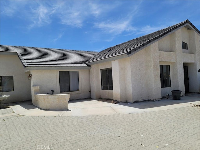 31801 Soapmine Rd, Barstow, CA 92311 - rear view of house featuring a patio, stucco siding, and a tile roof