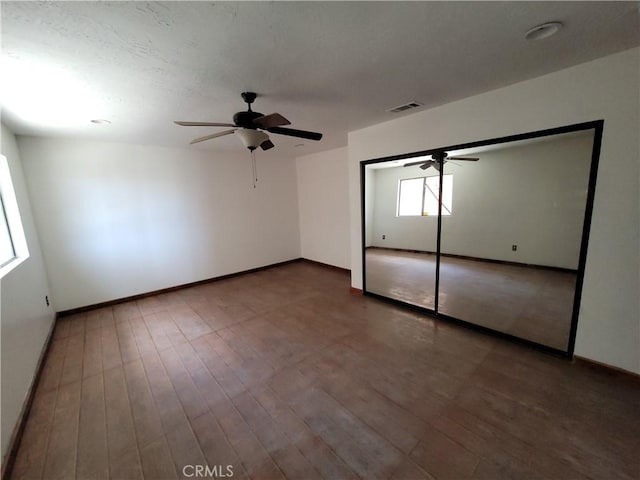 31801 Soapmine Rd, Barstow, CA 92311 - unfurnished bedroom with wood finished floors and ceiling fan