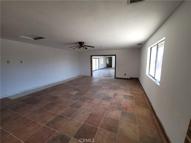 31801 Soapmine Rd, Barstow, CA 92311 - spare room with a ceiling fan and dark tile patterned flooring