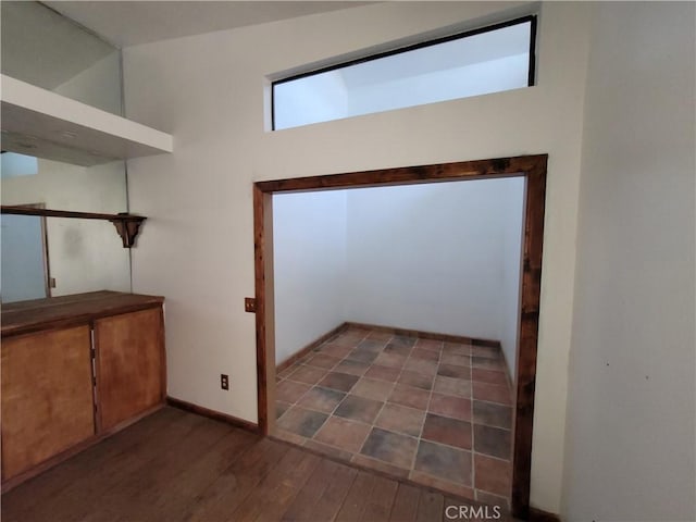 31801 Soapmine Rd, Barstow, CA 92311 - doorway featuring dark wood-type flooring and baseboards