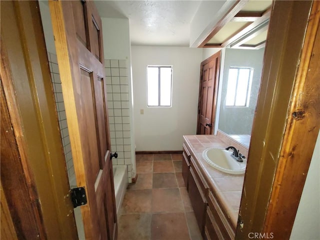 31801 Soapmine Rd, Barstow, CA 92311 - bathroom featuring vanity, plenty of natural light, washtub / shower combination, and tile patterned floors