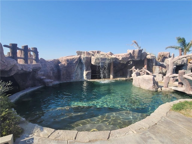 view of swimming pool featuring pool water feature