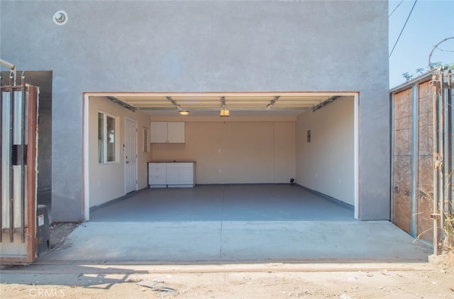 garage with a garage door opener and a carport
