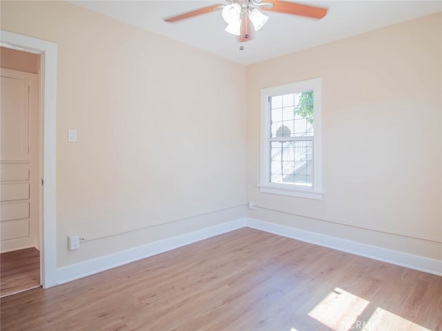 spare room with ceiling fan and light wood-type flooring