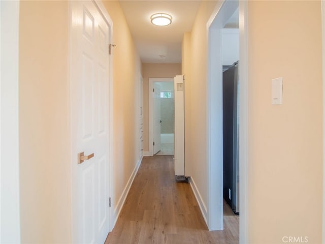 hall with light hardwood / wood-style floors
