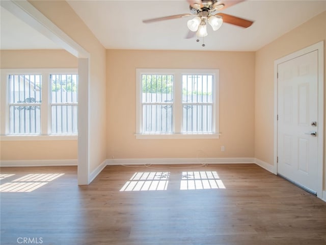 spare room with hardwood / wood-style floors and ceiling fan