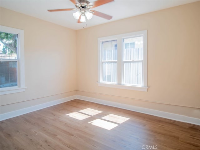 unfurnished room featuring ceiling fan, plenty of natural light, and light hardwood / wood-style flooring