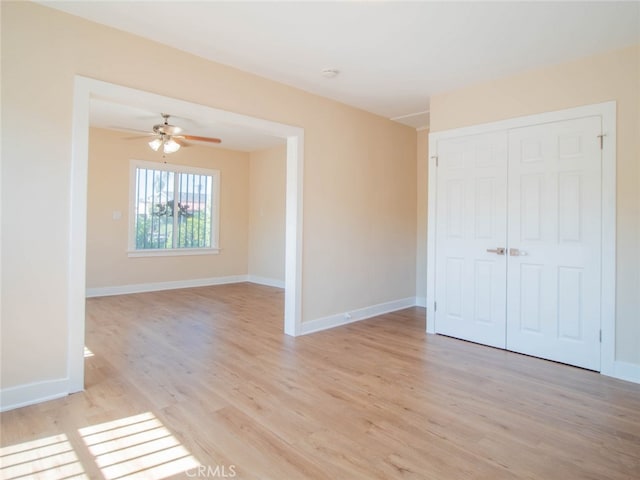 unfurnished room featuring light wood-type flooring and ceiling fan