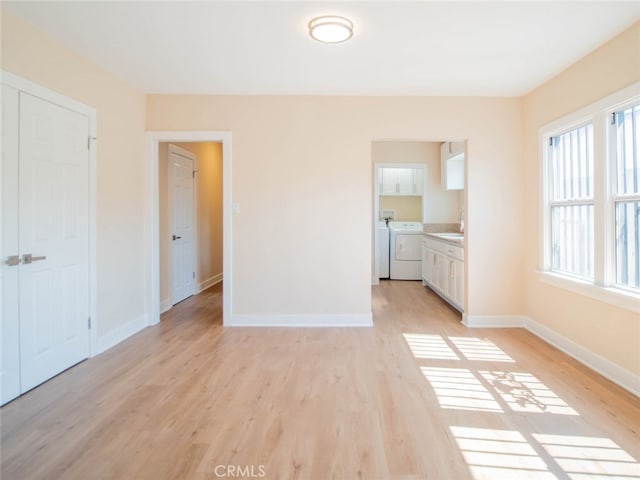 interior space featuring washer and dryer and light hardwood / wood-style floors