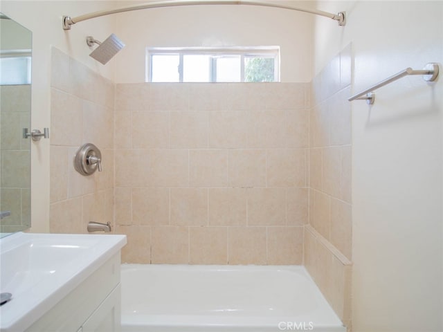 bathroom with vanity and tiled shower / bath combo