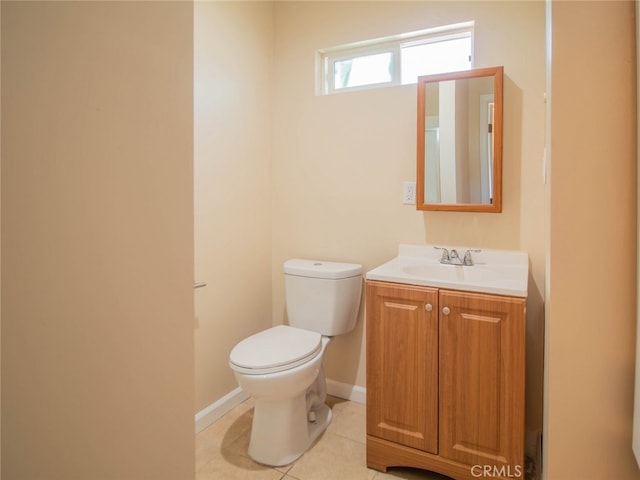 bathroom featuring tile patterned flooring, vanity, and toilet